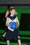 Boy Holding Dodgeball in Trampoline Arena